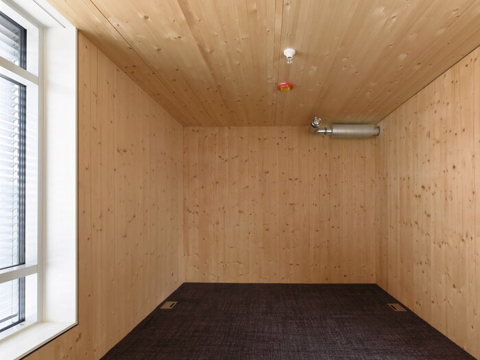 Die Holzwände im Schlafzimmer schaffen eine gemütliche Atmosphäre.